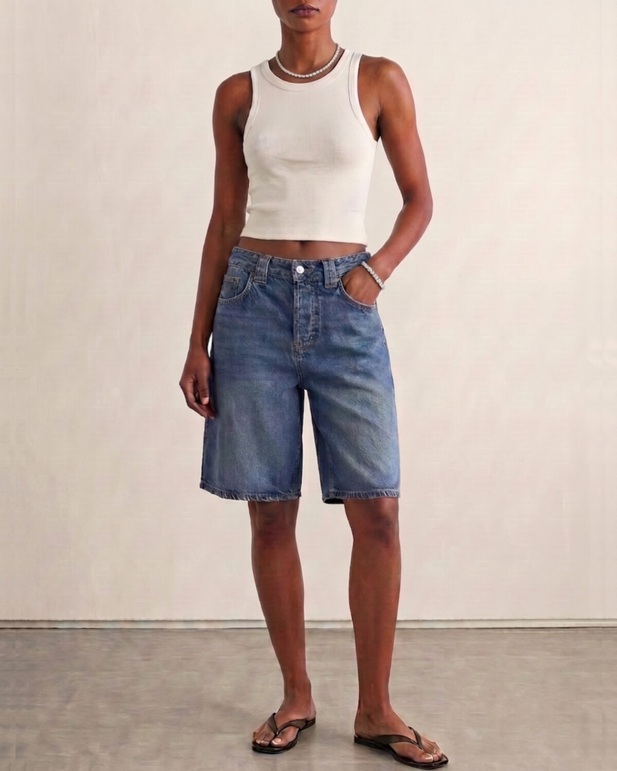 illi Collection Round-cut Diamond Tennis Necklace and Bracelet lookbook — Black model in white ribbed tank and medium-wash denim bermuda shorts